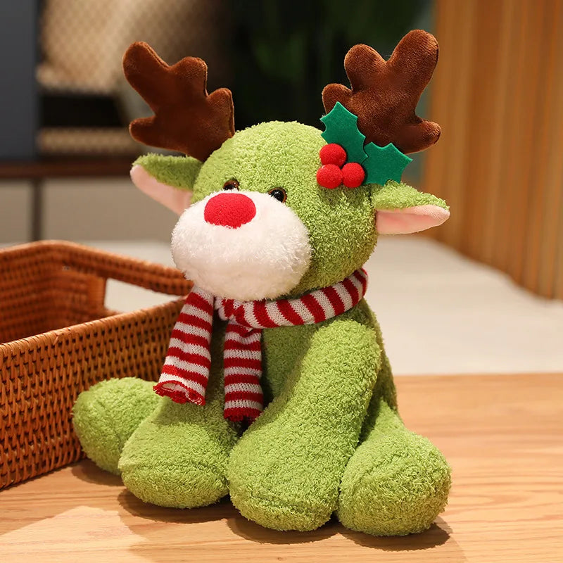 Green plush reindeer toy with a red scarf and holly leaf on a wooden surface.