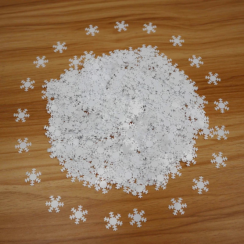 White snowflake confetti scattered on a wooden surface
