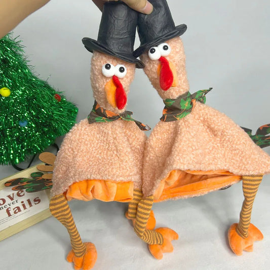 Two plush turkeys in pilgrim costumes with a green decorative item in the background.