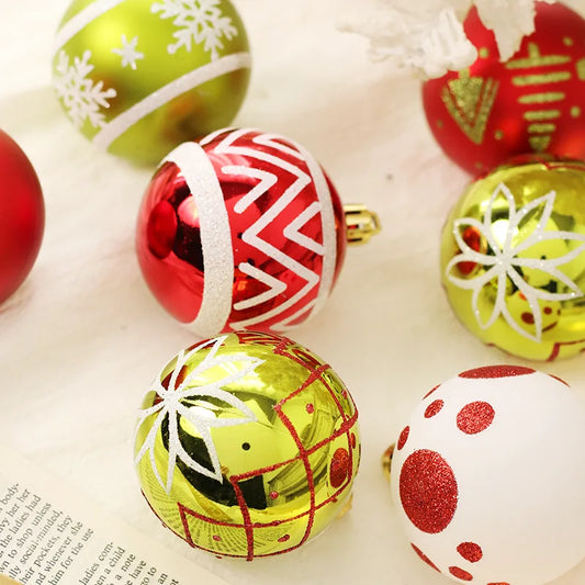Colorful Christmas ornaments on a white surface with a letter