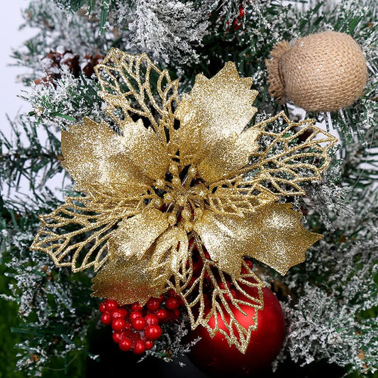 Decorative Christmas ornament with gold poinsettia, red berries, and a textured ball on a tree.