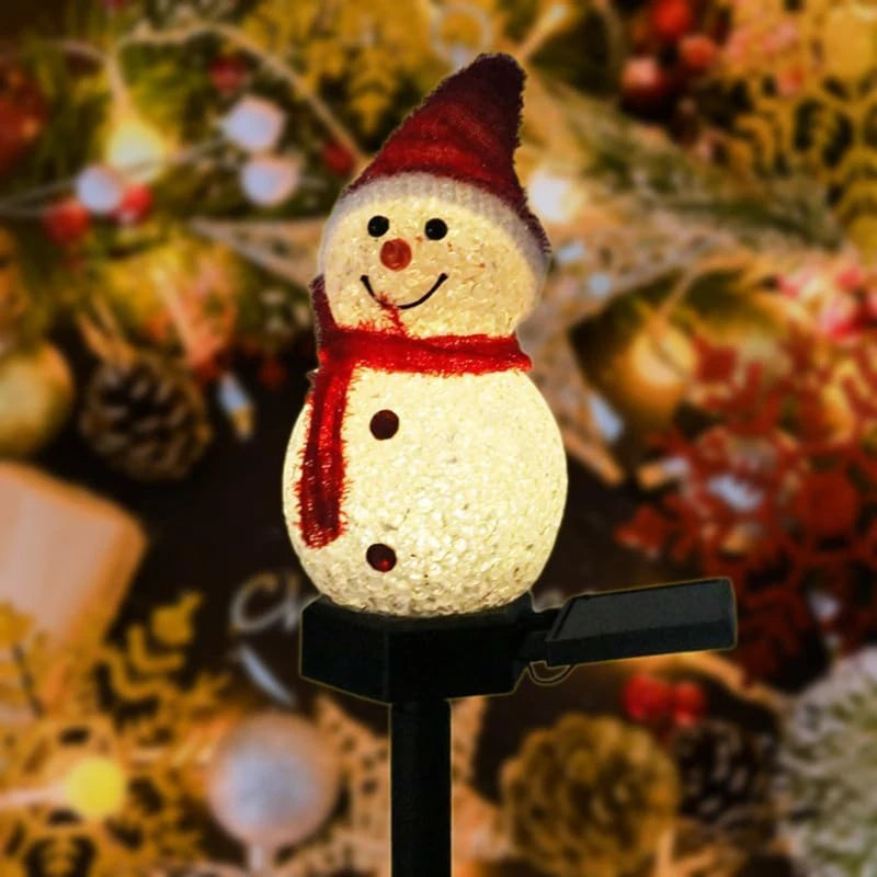 Decorative snowman light with a red scarf and hat on a blurred festive background