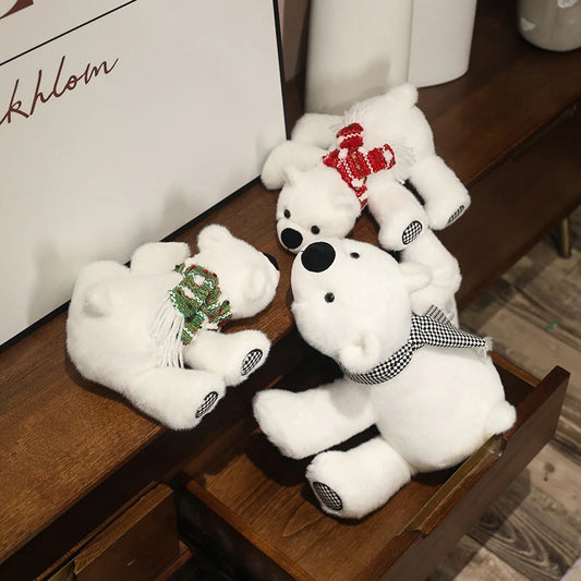 Three white teddy polar bears with decorative bows on a wooden surface.