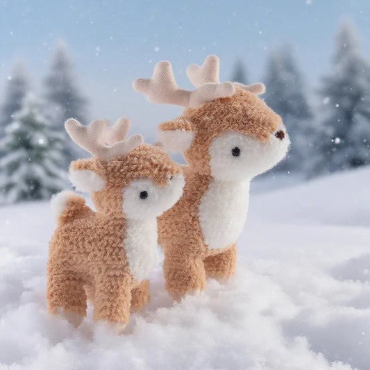 Two plush deer toys in a snowy landscape with trees in the background.
