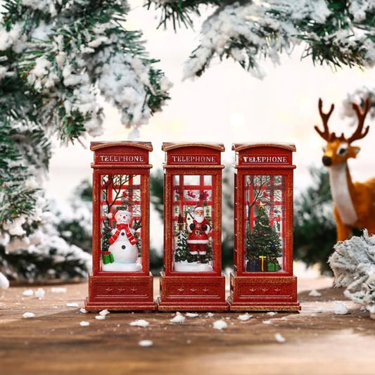 Three red Christmas-themed telephone booths with Santa Claus, snowman, and Christmas tree decorations against a snowy background with a deer.