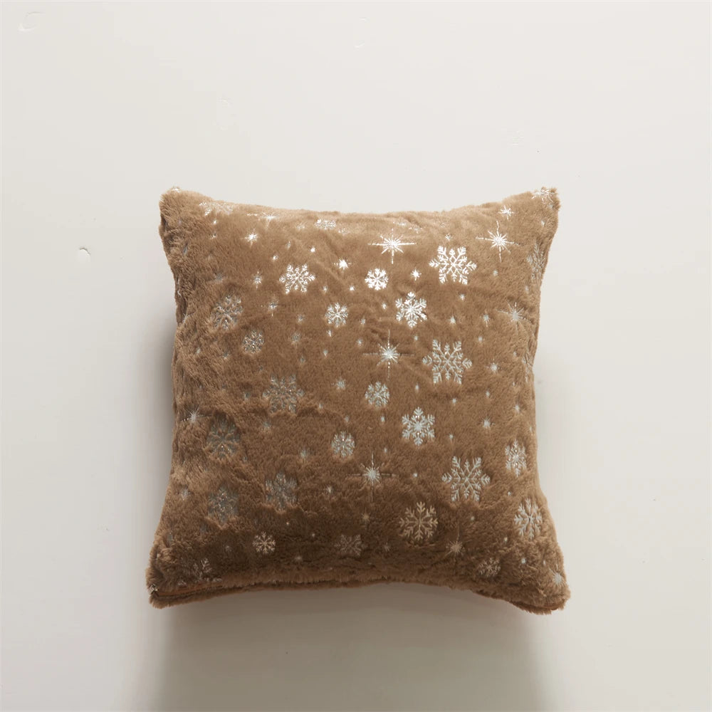Brown pillow with snowflake pattern on a light gray background
