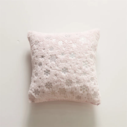 Snowflake patterned pillow on a light background