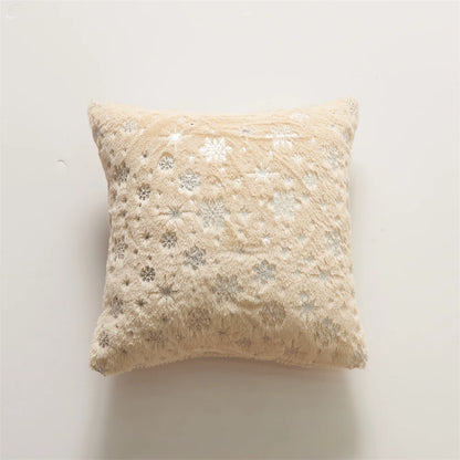 Fluffy beige pillow with silver sequin embellishments on a light gray background