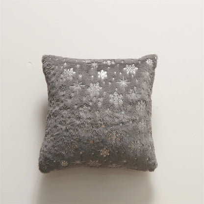 Gray pillow with snowflake pattern on a light gray background