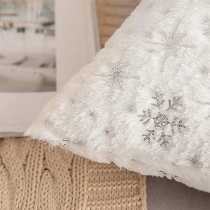 White textured blanket with snowflake patterns on a blurred indoor background