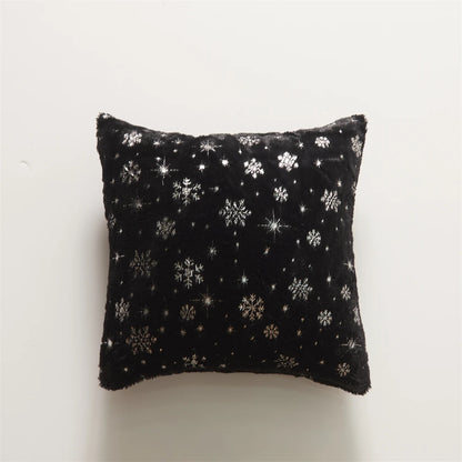Black pillow with silver snowflake pattern on a white background