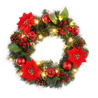 Decorative Christmas wreath with red flowers, pine cones, and lights on a white background