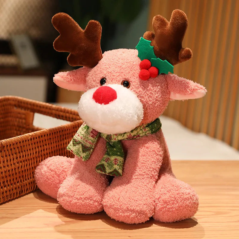 Pink plush reindeer toy with a green scarf and red nose on a wooden surface.