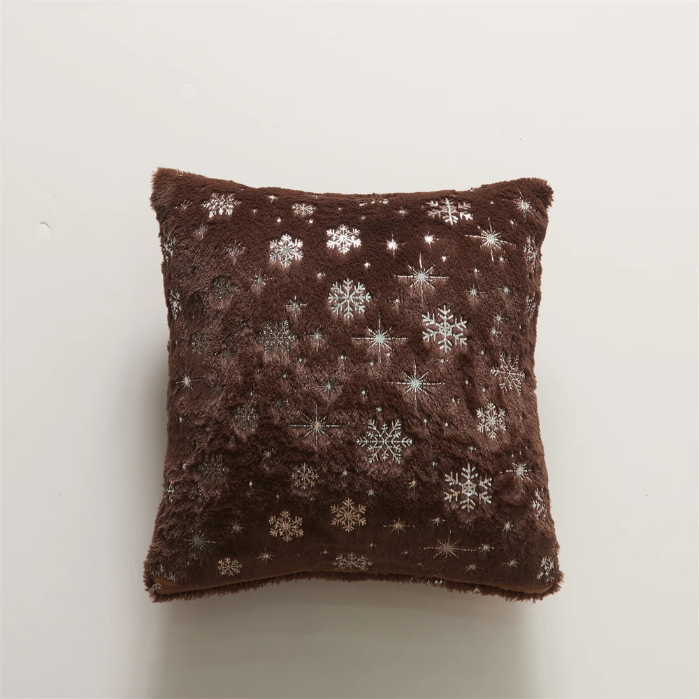 Brown pillow with snowflake patterns on a white background