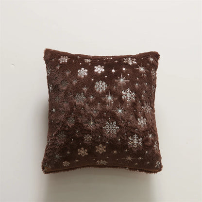 Brown pillow with snowflake patterns on a white background