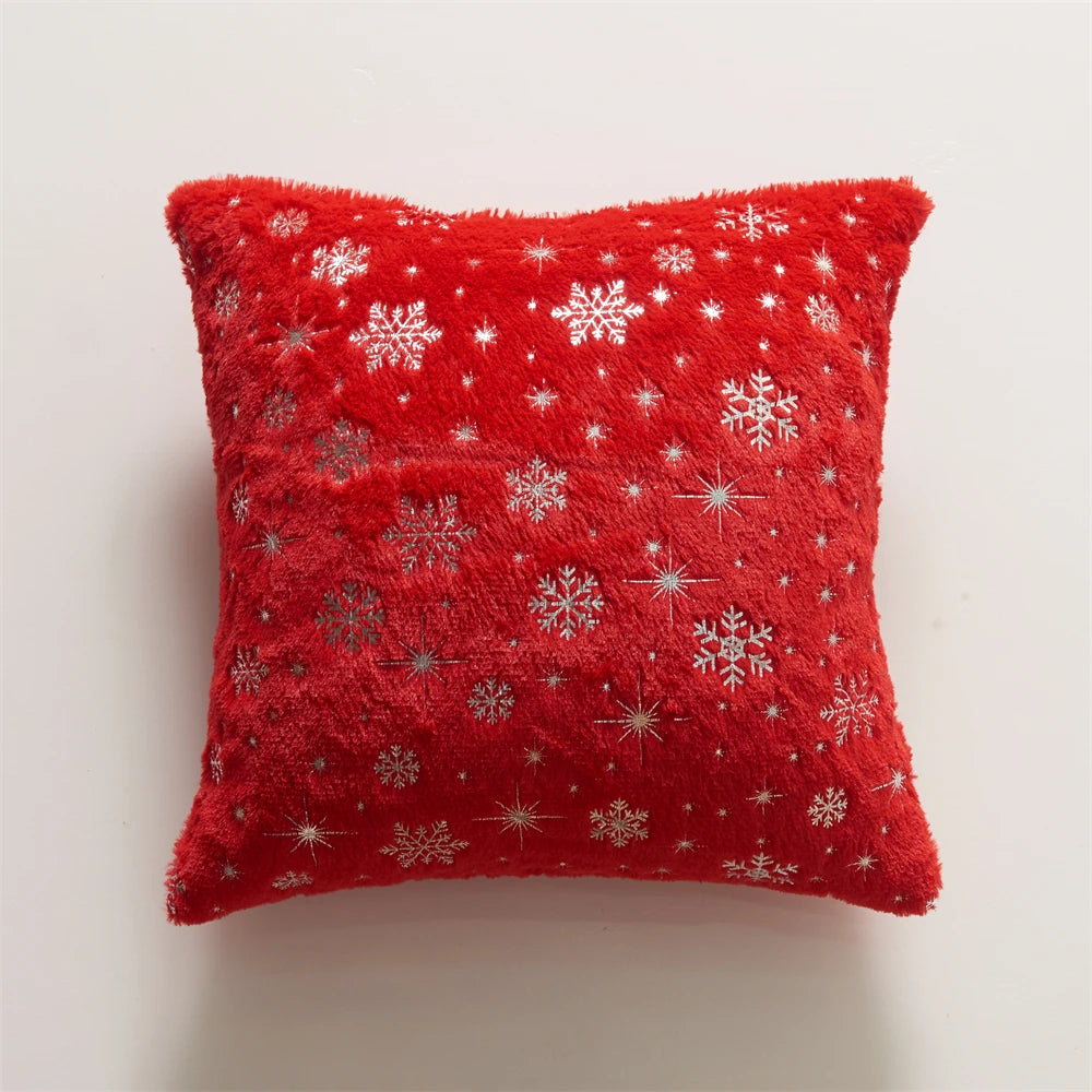 Red pillow with snowflake patterns on a light gray background