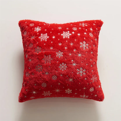 Red pillow with snowflake patterns on a light gray background