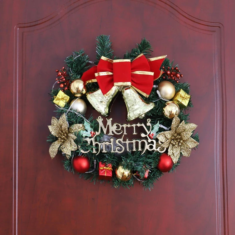 Decorative Christmas wreath with red bow, gold ornaments, and 'Merry Christmas' text on a wooden door.