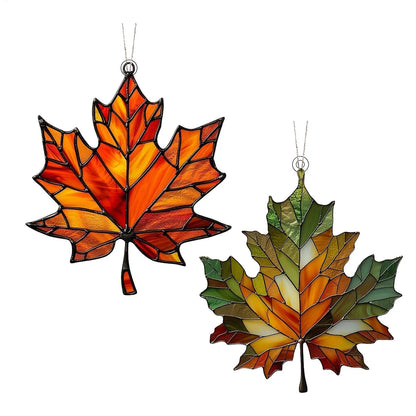 Two acrylic maple leaf ornaments on a white background