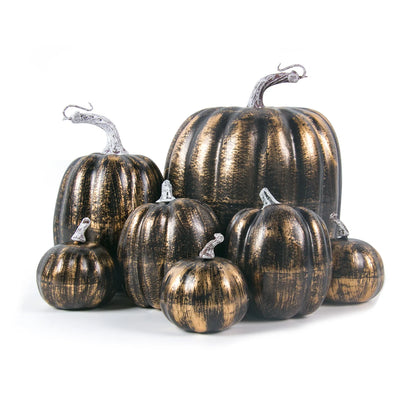 Set of metallic gold and black pumpkins on a white background