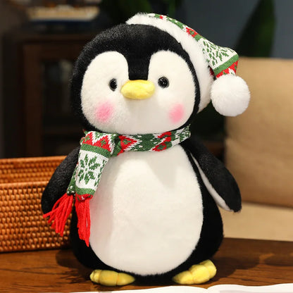 Plush penguin toy wearing a festive hat and scarf on a wooden surface.
