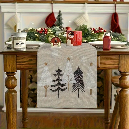 Decorative table runner with Christmas tree design on a wooden table.