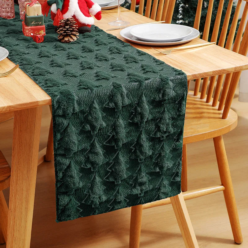 Green textured table runner on a wooden dining table with Christmas decor.