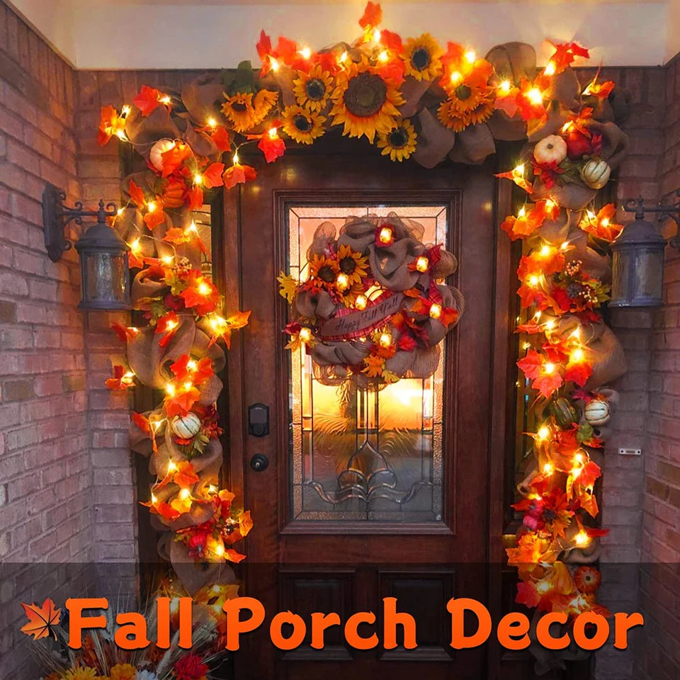 Decorative wreath with fall-themed elements on a door framed by lights and garlands.