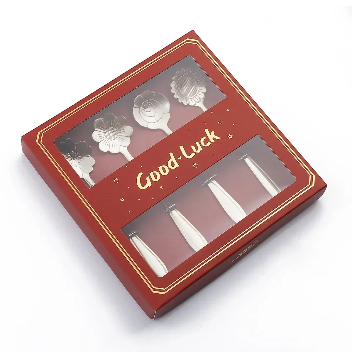 Red gift box with 'Good Luck' text and decorative items on a white background