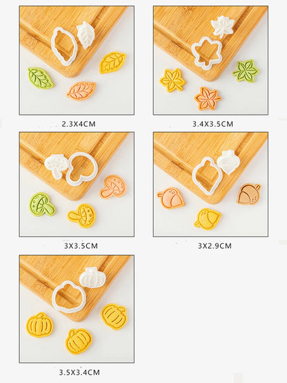 Set of cookie cutters with various shapes on a wooden board.