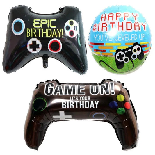 Three inflatable balloons shaped like game controllers with birthday messages on a white background.