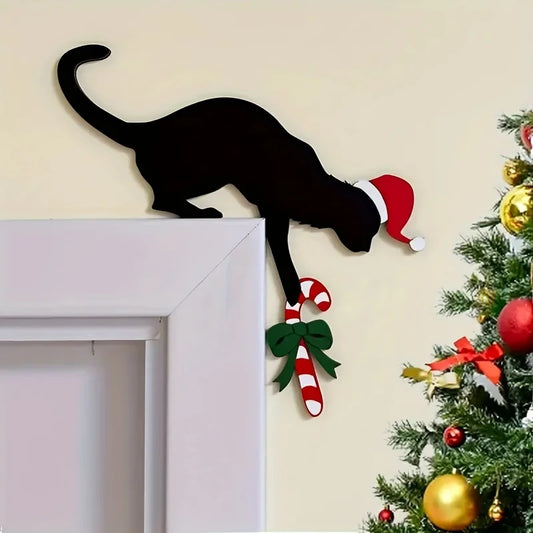 Decorative wall art of a black cat wearing a Santa hat with a candy cane and bow, next to a Christmas tree.