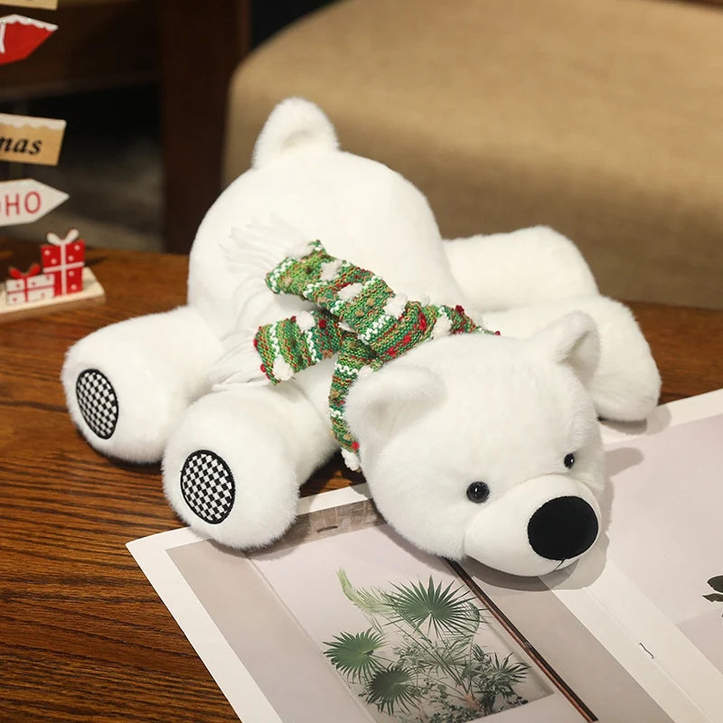 White teddy polar bear with a green sweater on a wooden surface