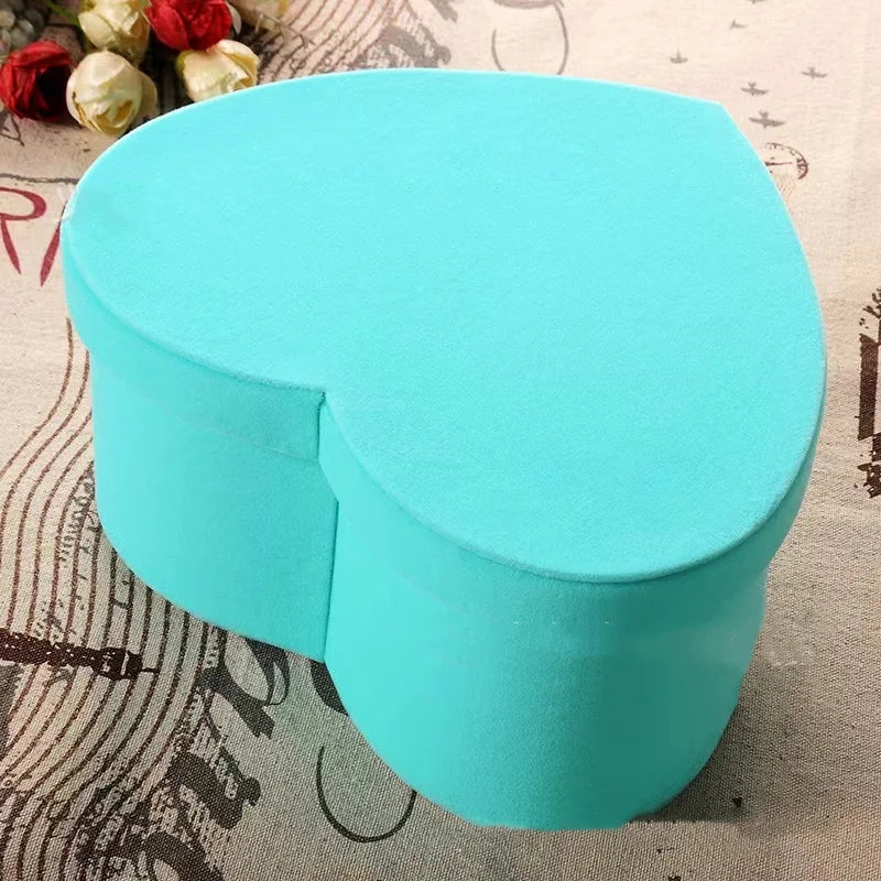 Turquoise silicone container on a textured surface with flowers in the background