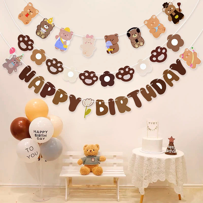Birthday party setup with teddy bear-themed decorations, balloons, and a cake.