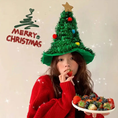 Person wearing a Christmas tree hat with festive decorations, holding a plate of fruits, and the text 'Merry Christmas' on a light background.