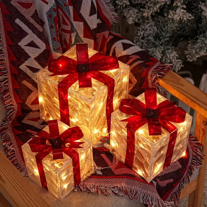 Decorative lights shaped like presents with red bows on a textured surface.
