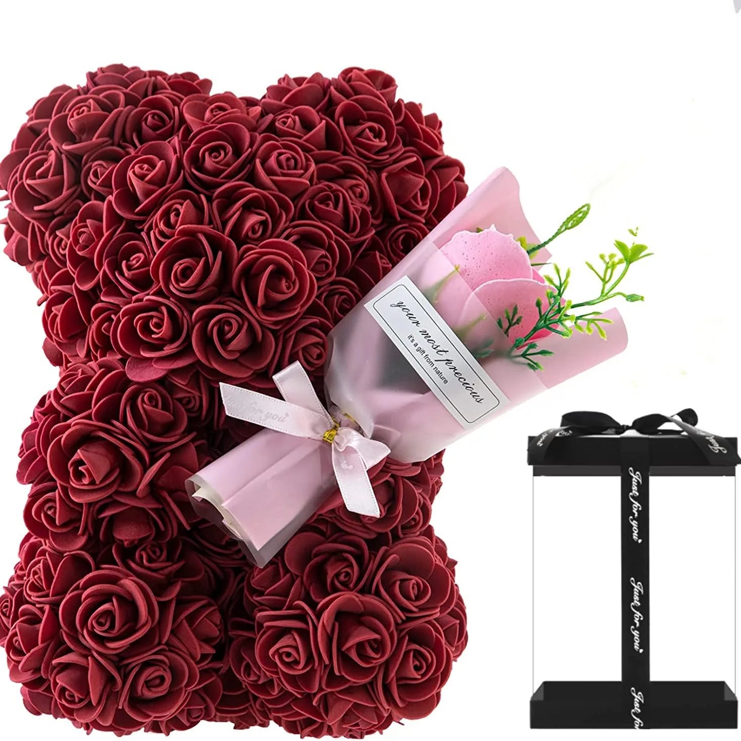 Red rose teddy bear with a small bouquet of pink roses and a black stand on a white background