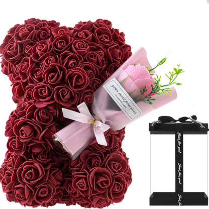 Red rose teddy bear with a small bouquet of pink roses and a black stand on a white background