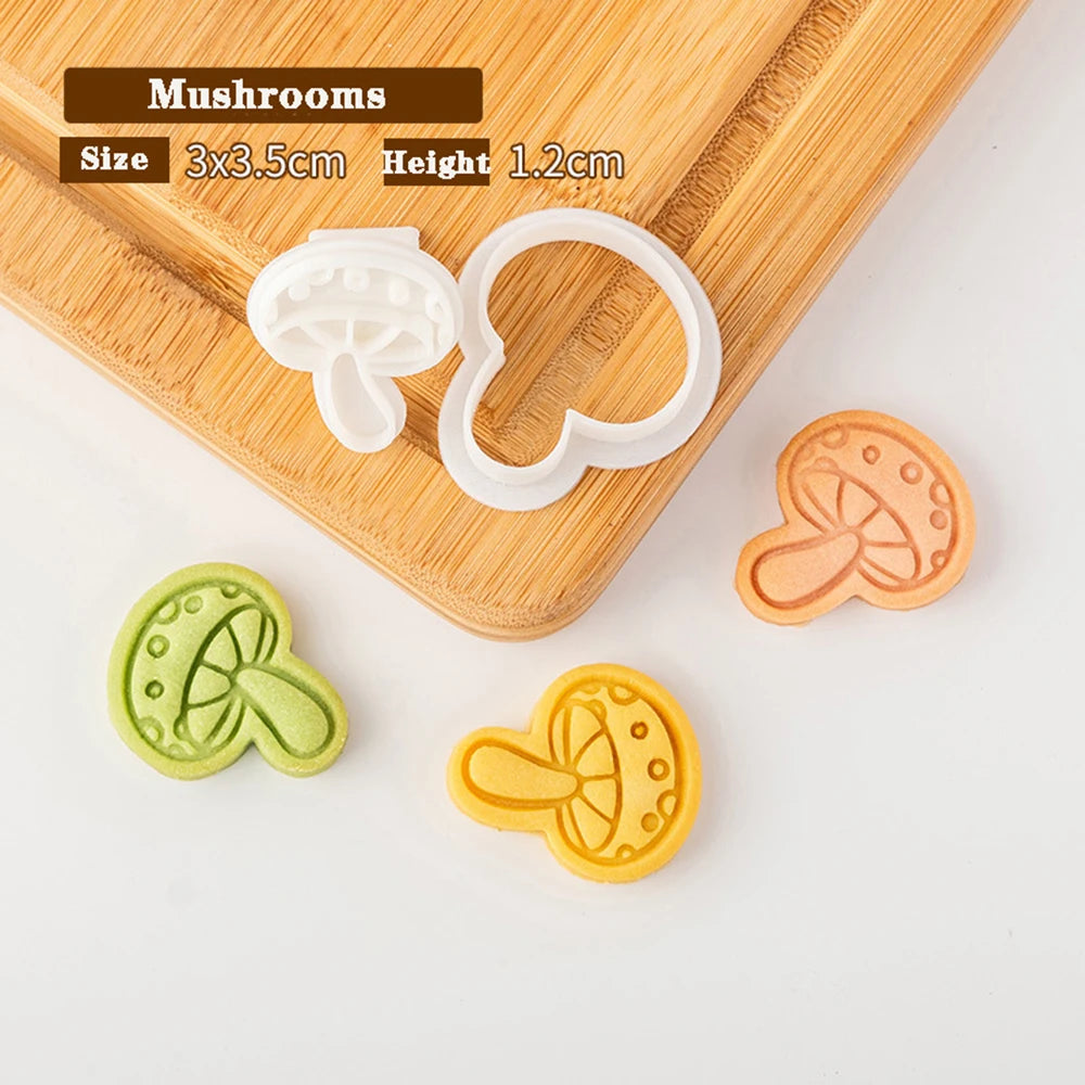 Mushroom-shaped cookie cutters on a wooden board with measurements.