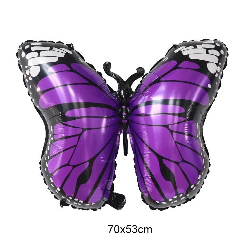 Purple butterfly-shaped balloon on a white background