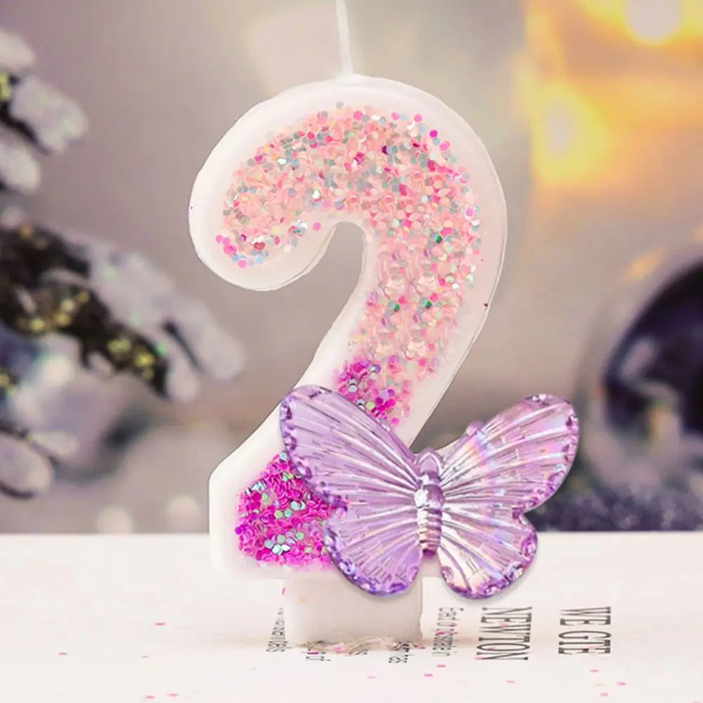 Decorative number '2' with pink glitter and a purple butterfly on a blurred background