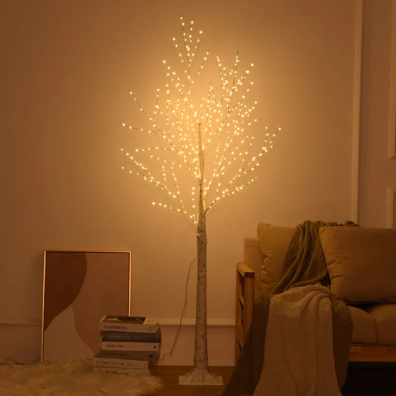 Decorative light tree in a living room setting with books and a mirror.
