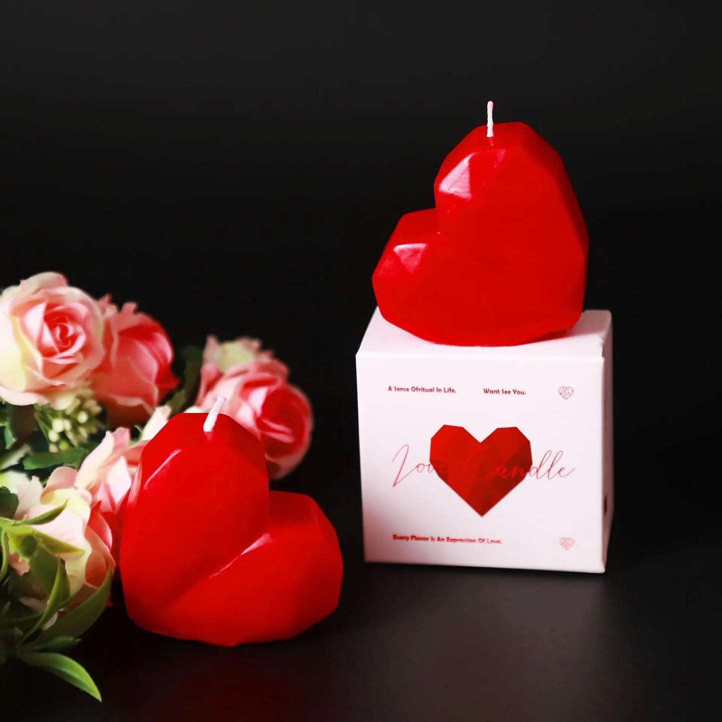 Heart-shaped red candles with a box labeled 'Love Candle' on a dark background.