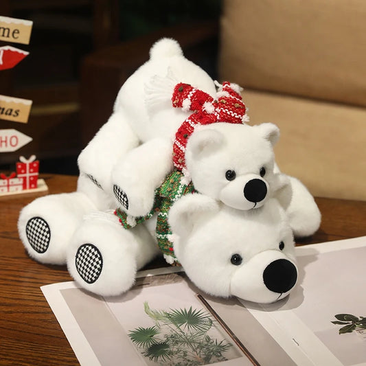 Two white teddy polar bears with a red bow on a wooden surface.