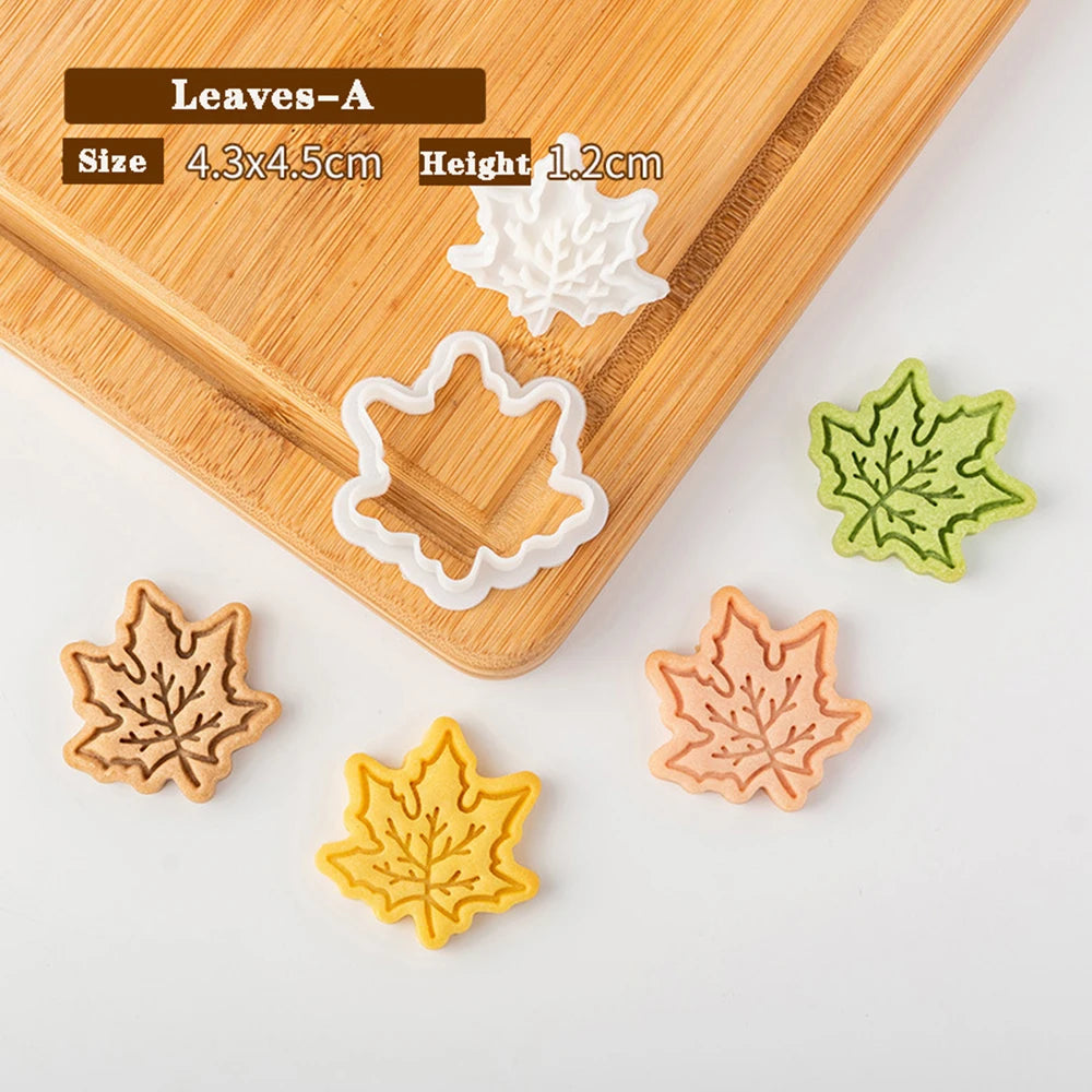 Leaf-shaped cookie cutters on a wooden board with measurements displayed.