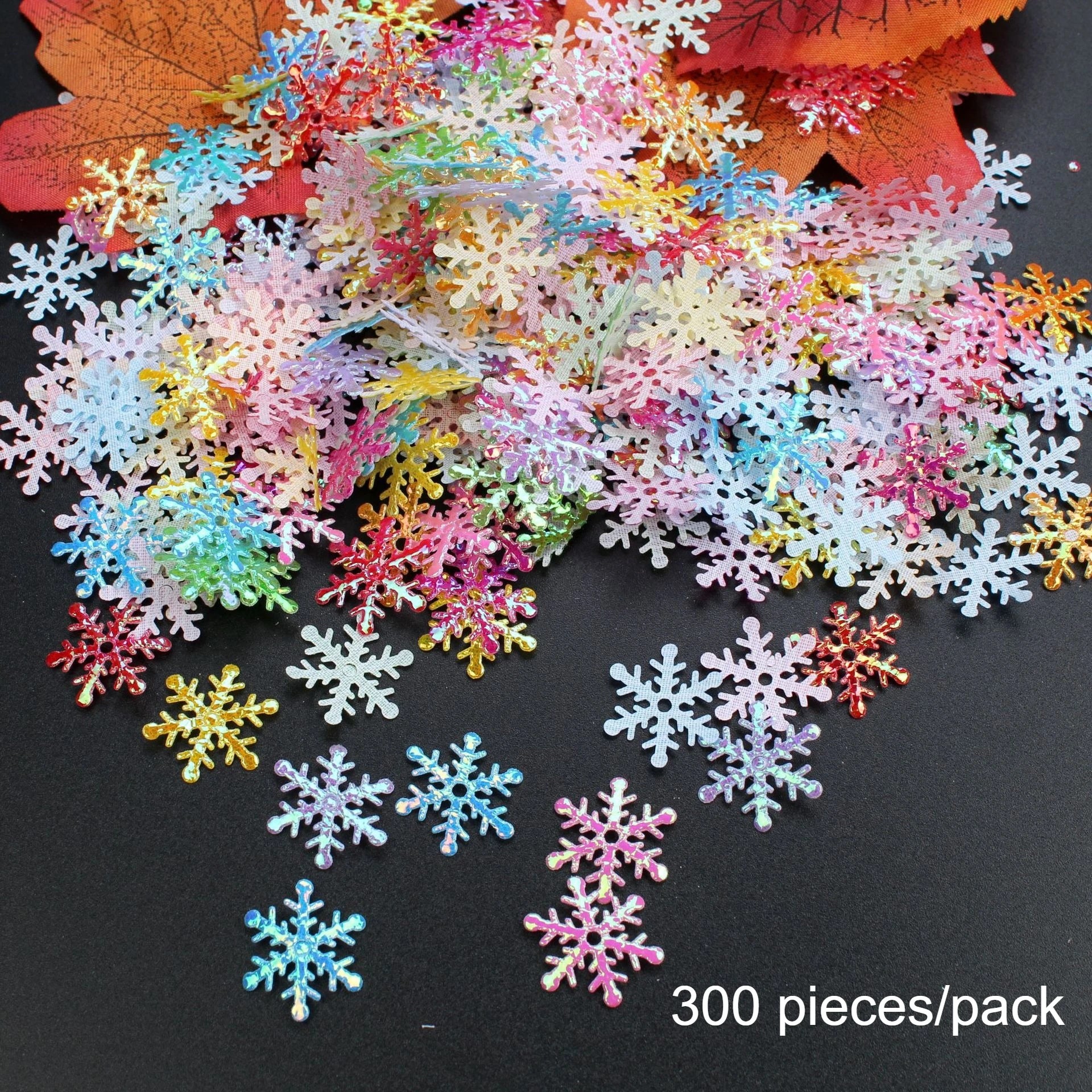 Colorful snowflake decorations on a black background with text '300 pieces/pack'.