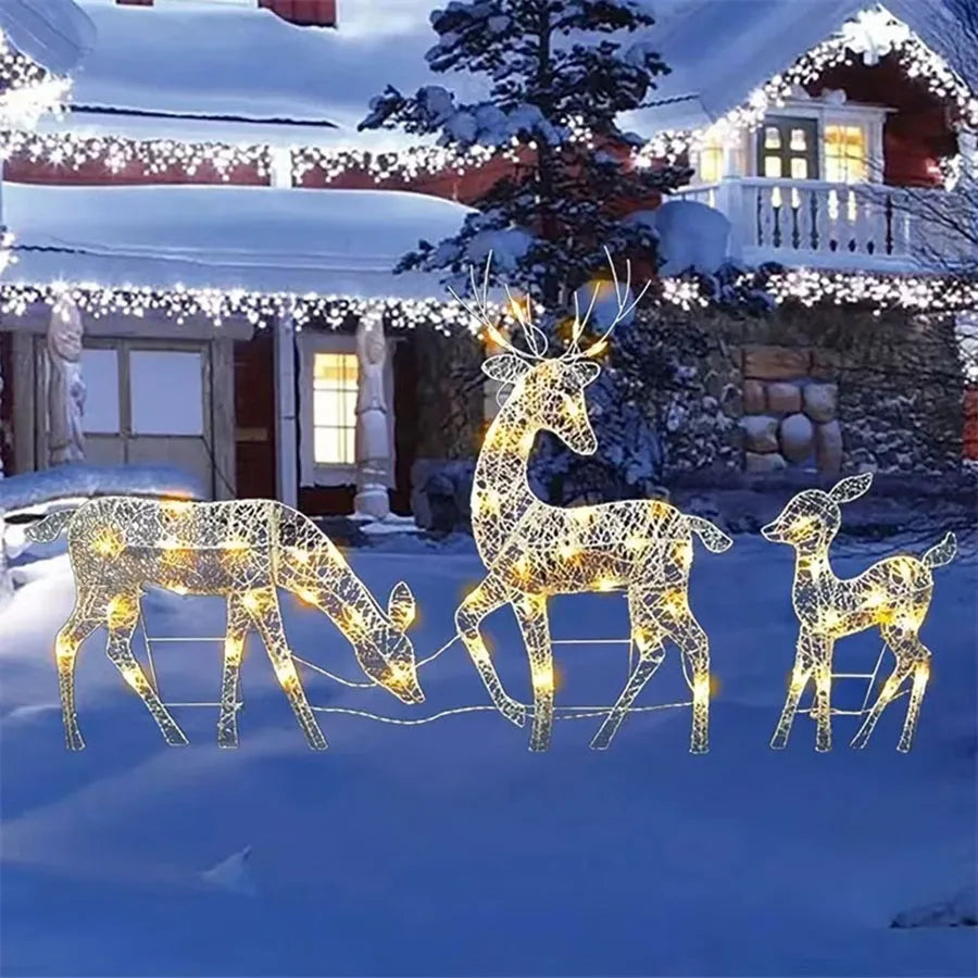Decorative LED deer set in front of a house with Christmas lights.