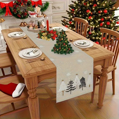 Dining table set for Christmas with a decorated tree and table runner.