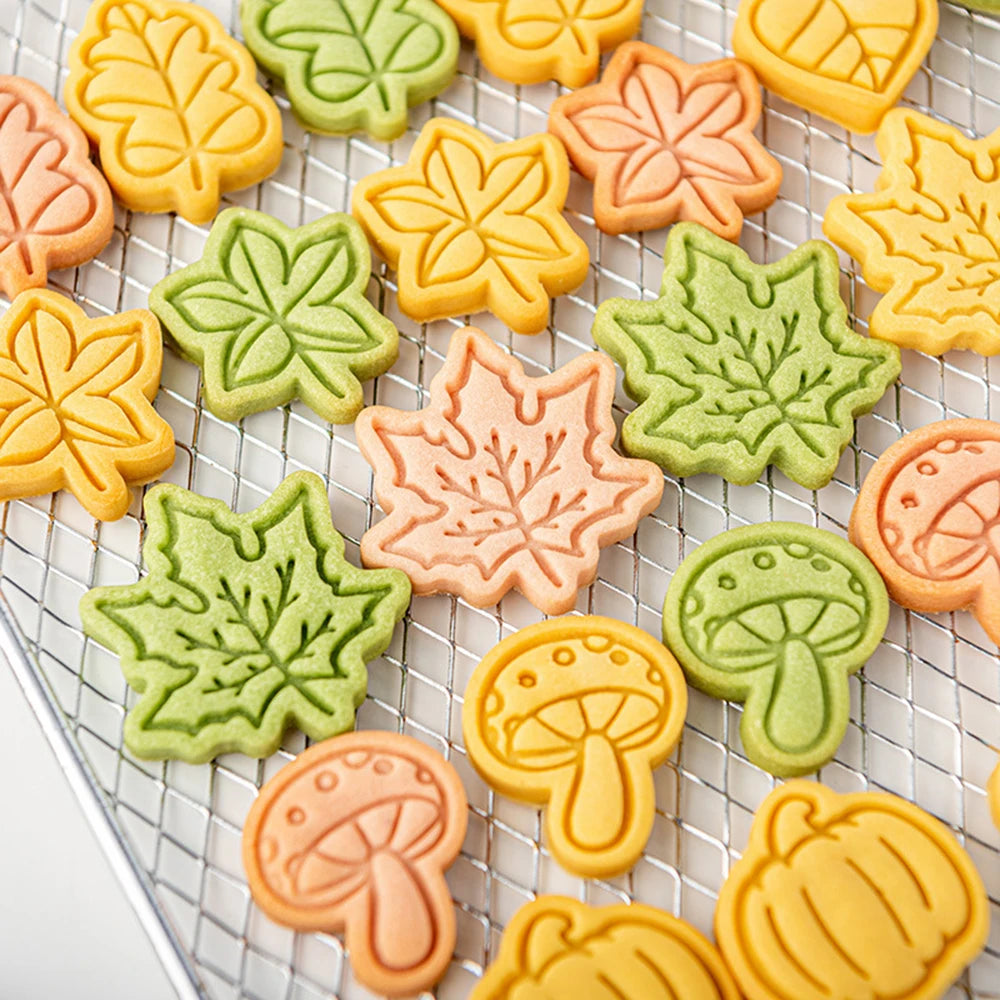 Colorful leaf and mushroom-shaped cookies on a cooling rack.